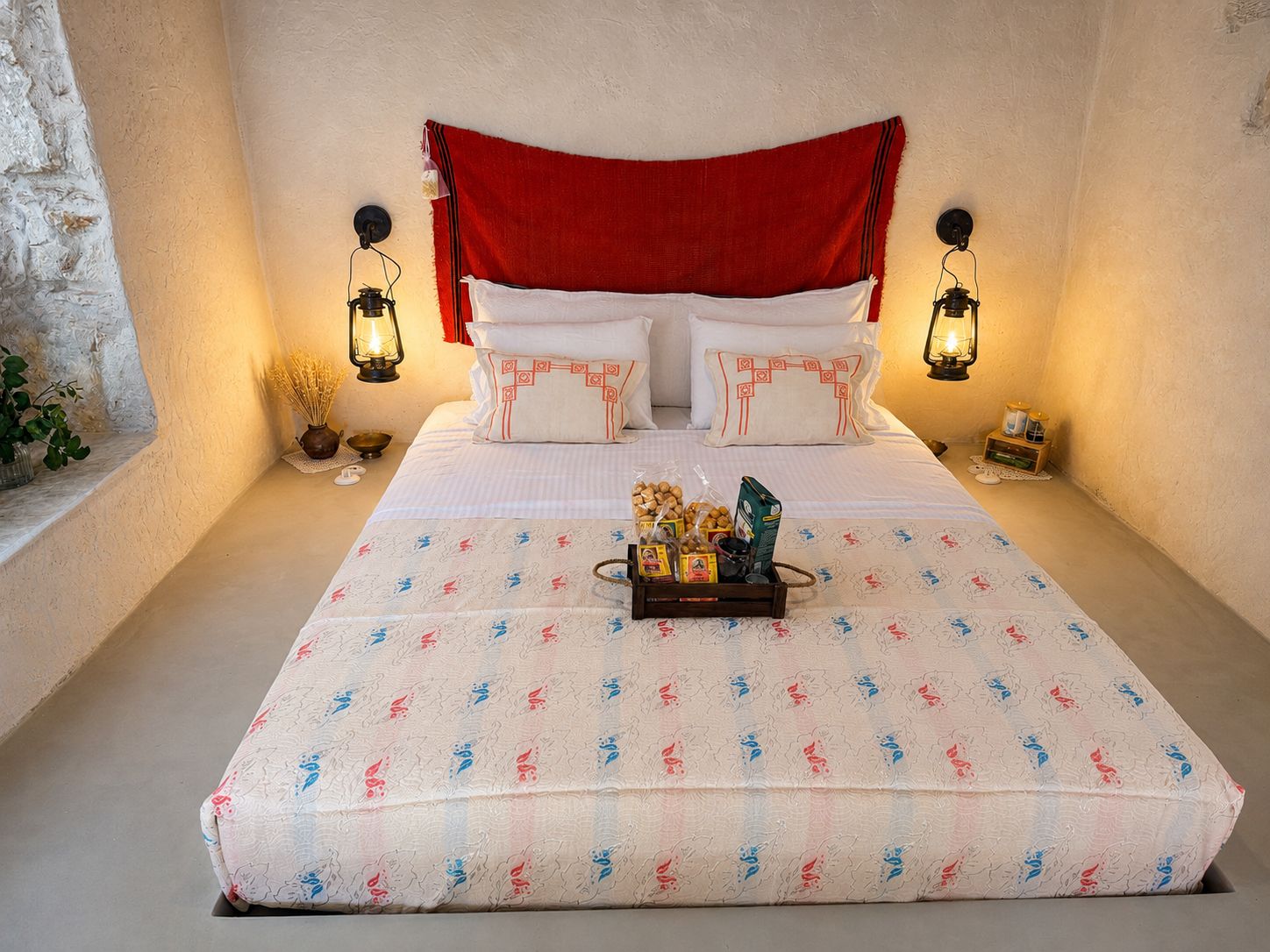 The bedroom seen head-on, lantern-lit