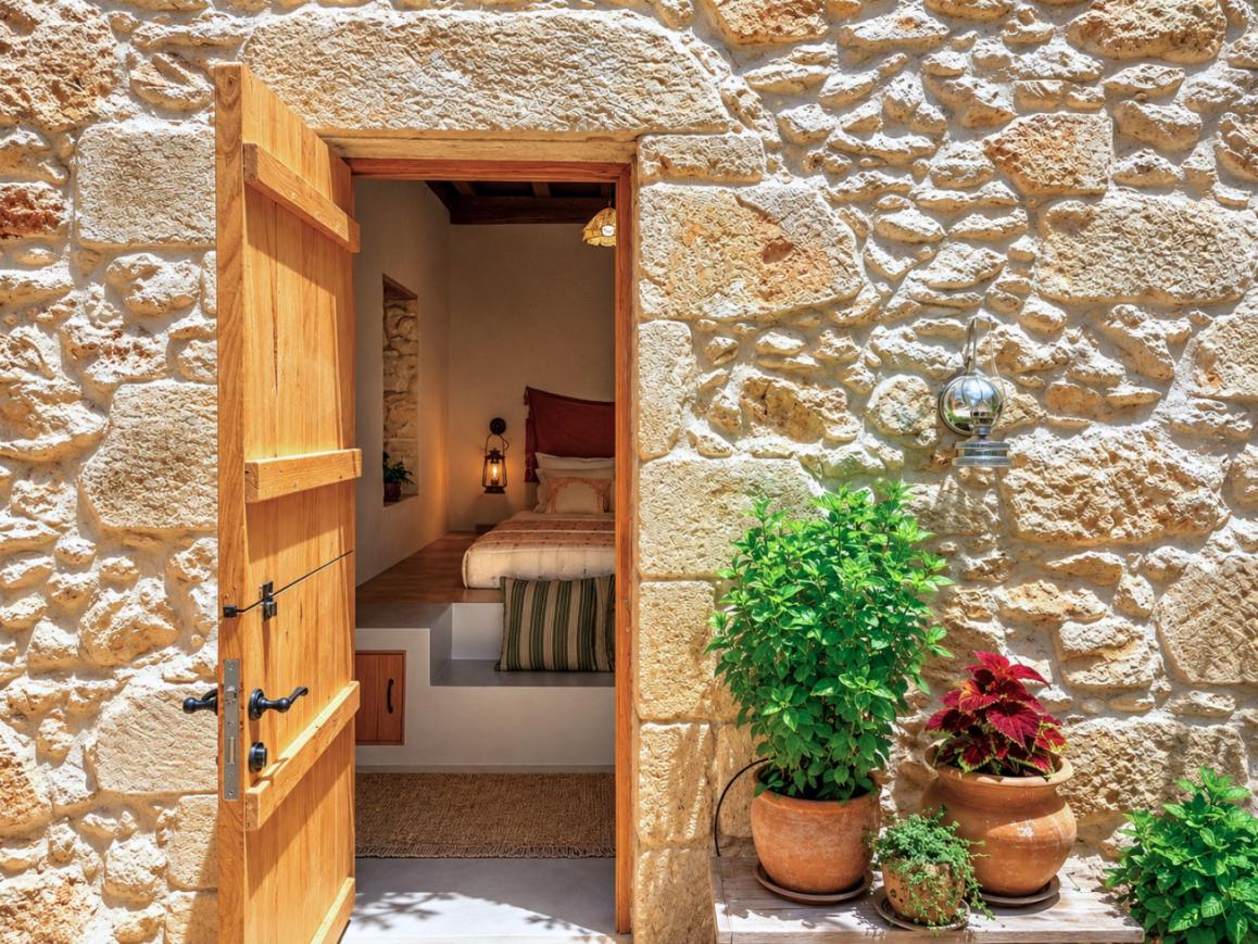 The wooden door open onto the bedroom